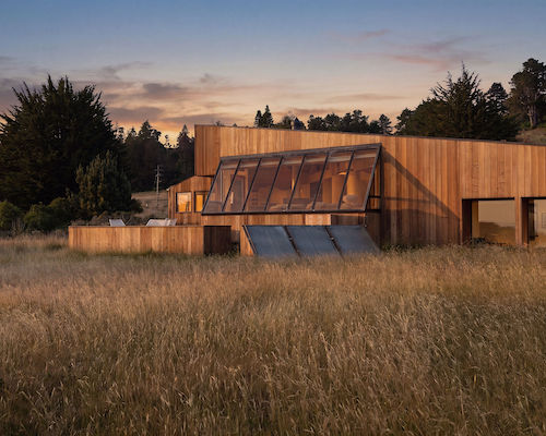 Angular wooden building with angled glass windows